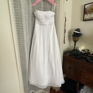 It is a david’s bridal wedding dress, new without tags, and has been dry cleaned